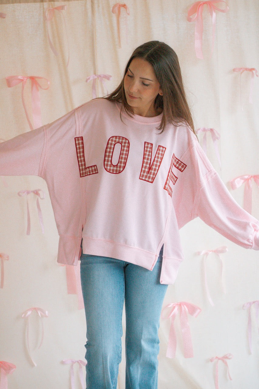 light bubblegum pink Terry cloth pullover with raw hem details, front slits, and red patchwork embroidered love
