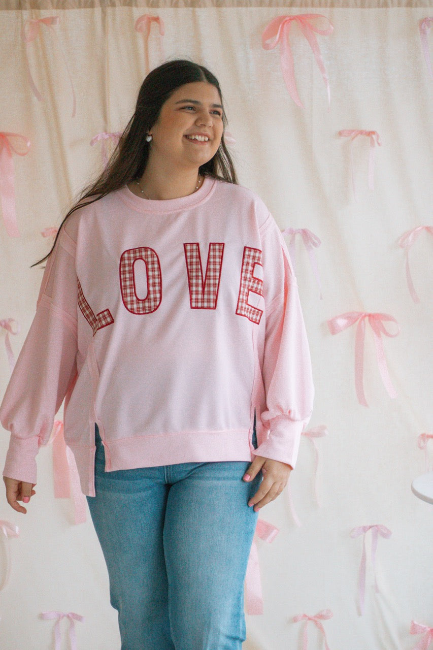 light bubblegum pink Terry cloth pullover with raw hem details, front slits, and red patchwork embroidered love