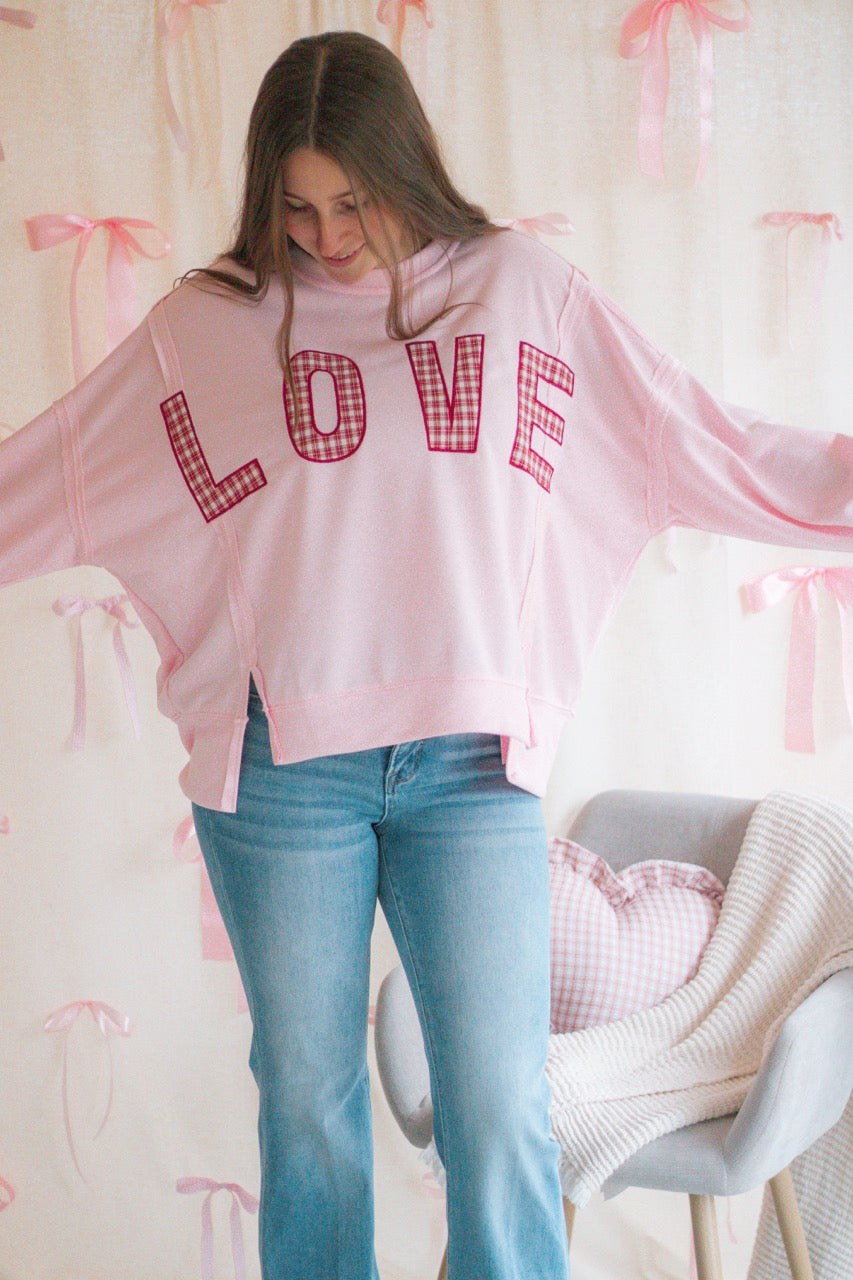 light bubblegum pink Terry cloth pullover with raw hem details, front slits, and red patchwork embroidered love