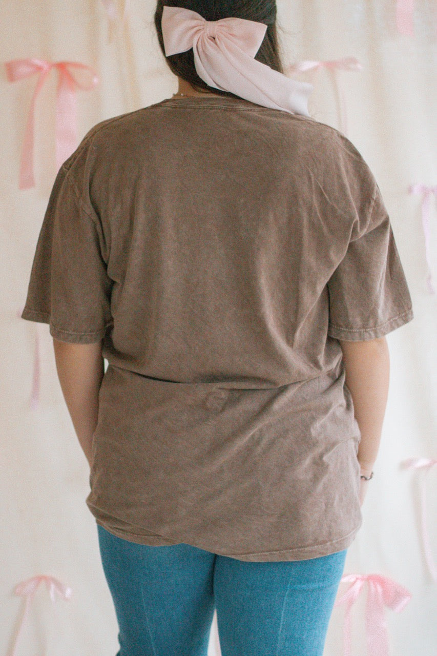 A brown acid mineral wash oversized t-shirt with the work Loved John 3:16 printed on the front
