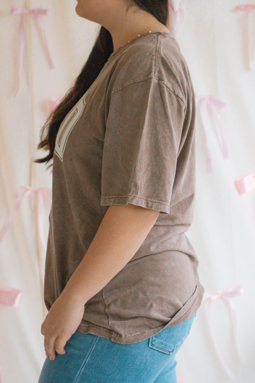 A brown acid mineral wash oversized t-shirt with the work Loved John 3:16 printed on the front