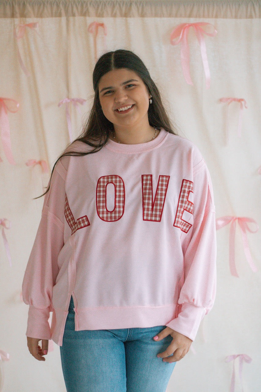 light bubblegum pink Terry cloth pullover with raw hem details, front slits, and red patchwork embroidered love