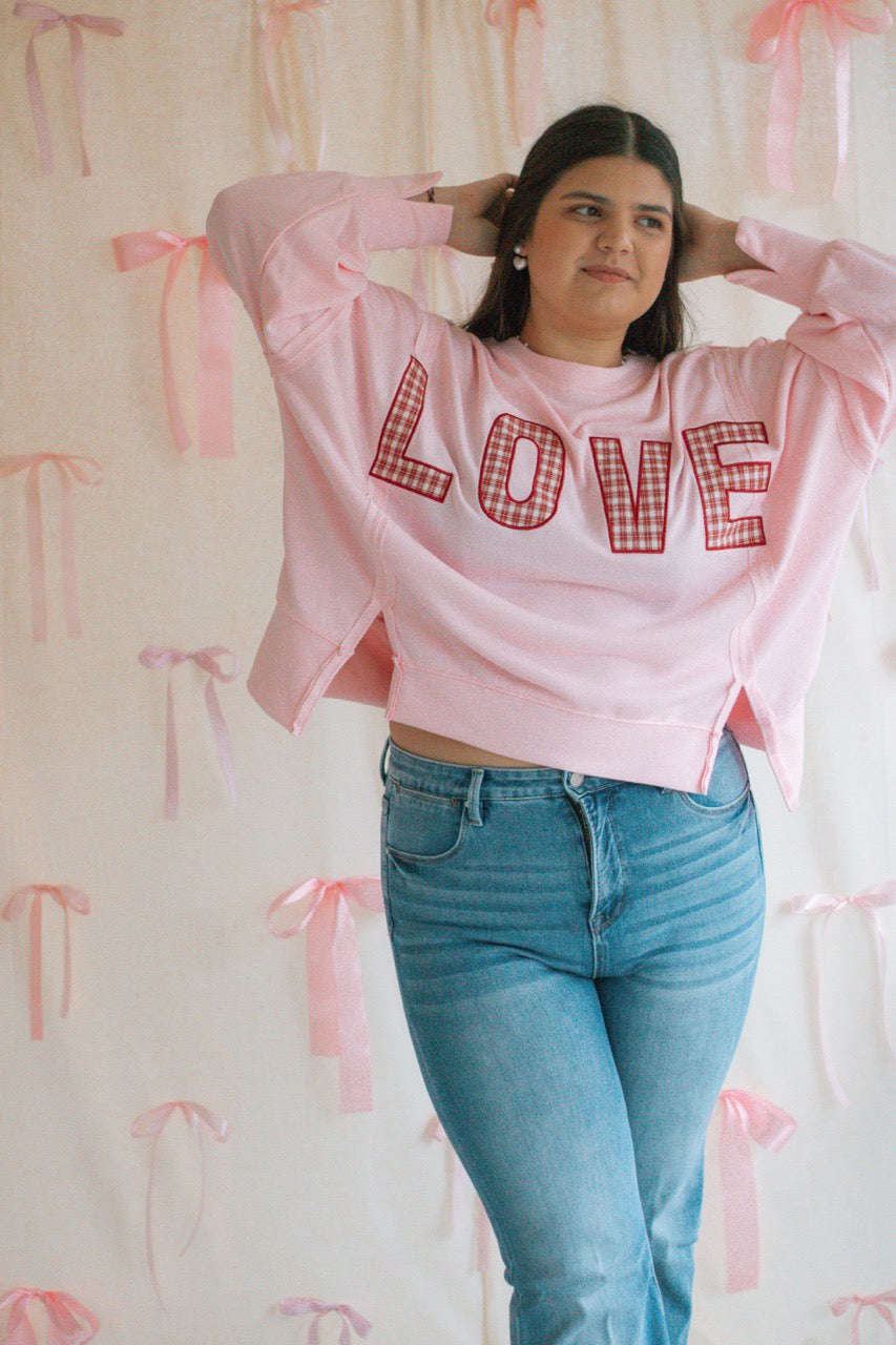 light bubblegum pink Terry cloth pullover with raw hem details, front slits, and red patchwork embroidered love