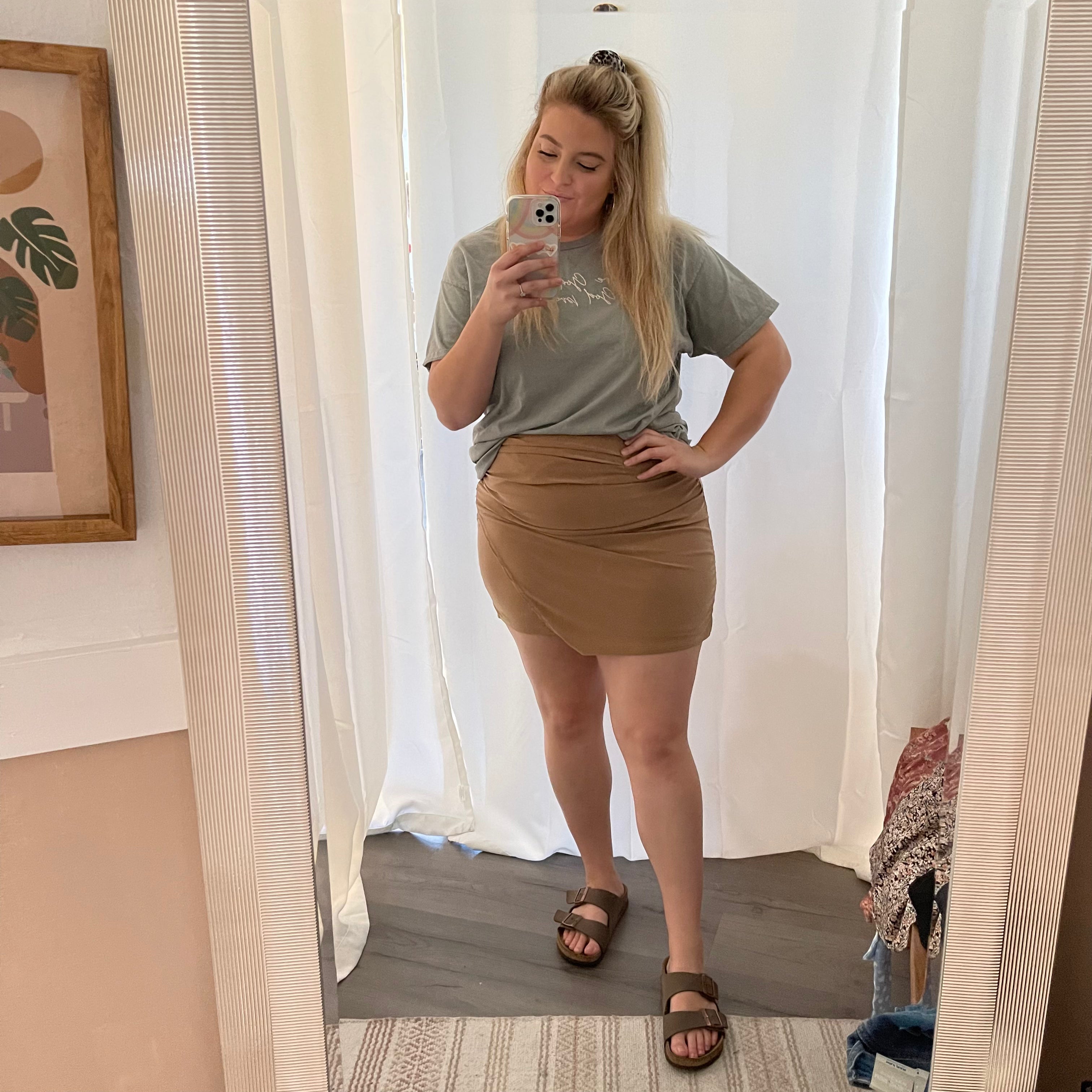 A mid thigh fitted faux wrap mini skirt in the color brown/tan